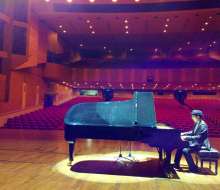 Carlo Aspri rehearsing his music compositions in a beautiful theater before his evening performance, in Xiamen city, Fujian Province, China,