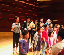 Many fans gather as a group to take photos with Carlo Aspri after the performance..