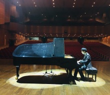 Carlo Aspri practices his original songs at a beautiful theater in China right before his performance.
